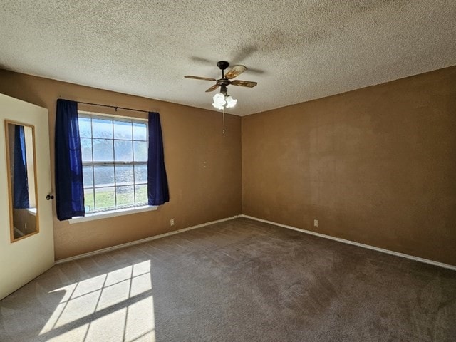 carpeted empty room featuring a textured ceiling and ceiling fan