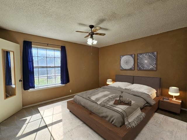 carpeted bedroom with ceiling fan and a textured ceiling