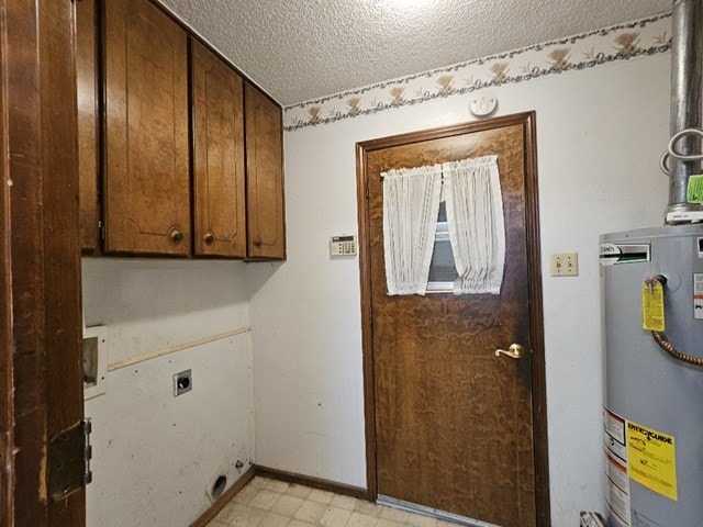 clothes washing area featuring water heater, washer hookup, hookup for an electric dryer, a textured ceiling, and cabinets