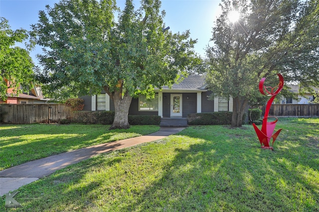 obstructed view of property featuring a front yard