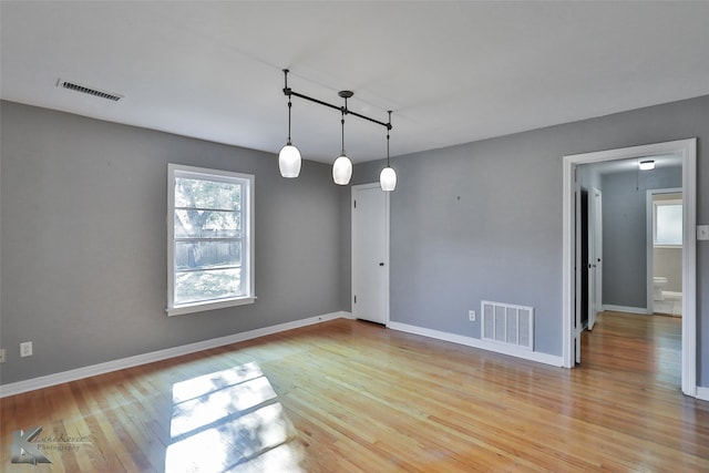 spare room featuring light hardwood / wood-style flooring