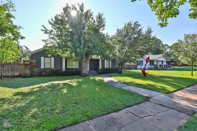 obstructed view of property with a front lawn