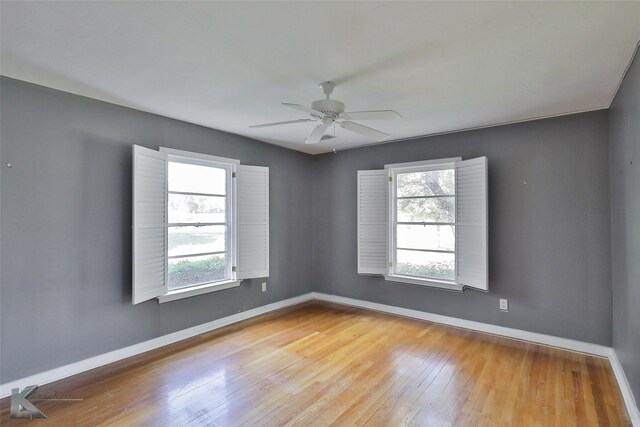 empty room featuring light hardwood / wood-style floors, ceiling fan, and a healthy amount of sunlight