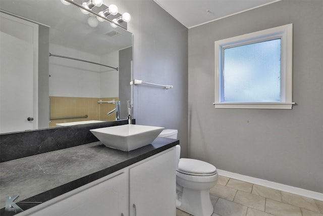 bathroom featuring tile patterned flooring, vanity, and toilet