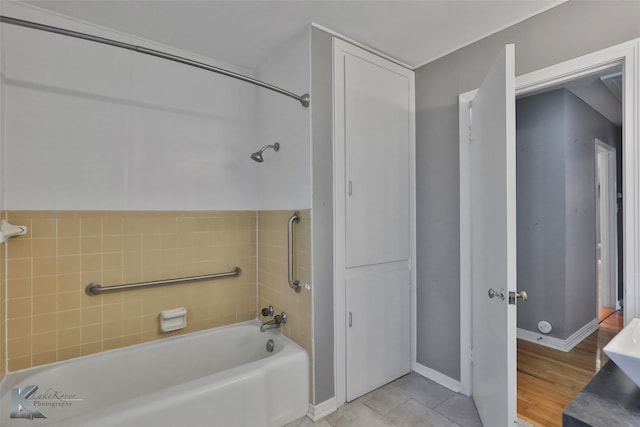 bathroom with shower / bath combination and hardwood / wood-style floors