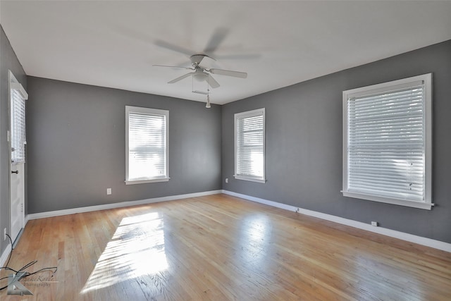 unfurnished room with light wood-type flooring, a healthy amount of sunlight, and ceiling fan