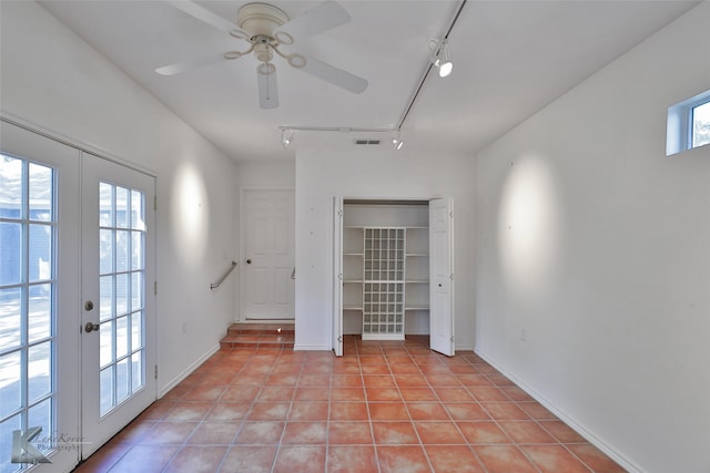 unfurnished room featuring light tile patterned floors, ceiling fan, french doors, and rail lighting