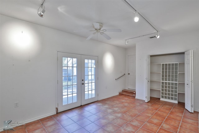 spare room featuring rail lighting, light tile patterned floors, ceiling fan, and french doors