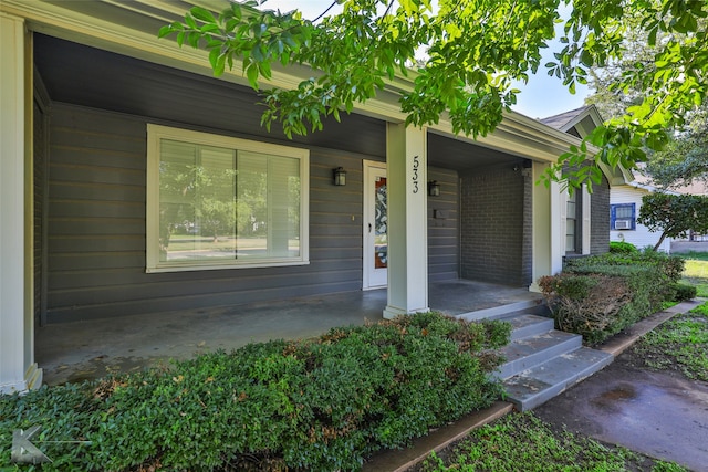 doorway to property featuring covered porch