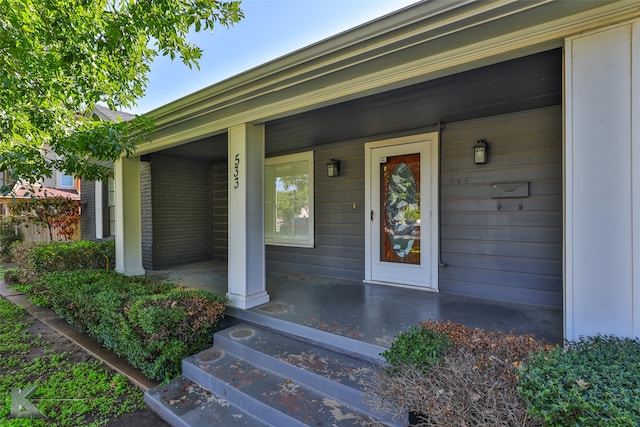 doorway to property featuring covered porch