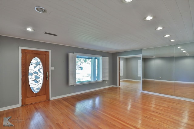 entrance foyer with light wood-type flooring and wood ceiling