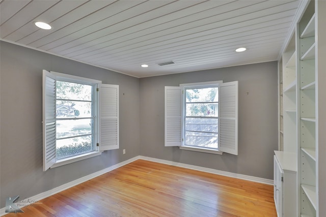 empty room with wooden ceiling and light hardwood / wood-style flooring