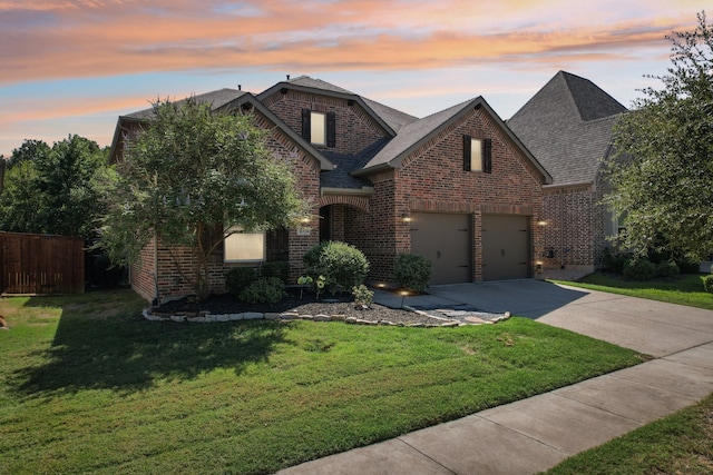 view of front facade with a lawn and a garage