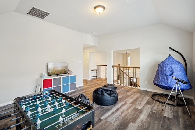 recreation room featuring hardwood / wood-style flooring and lofted ceiling