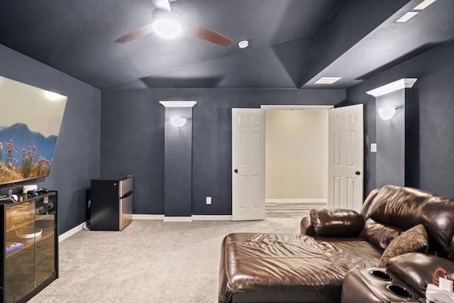 home theater featuring ceiling fan, carpet floors, and lofted ceiling