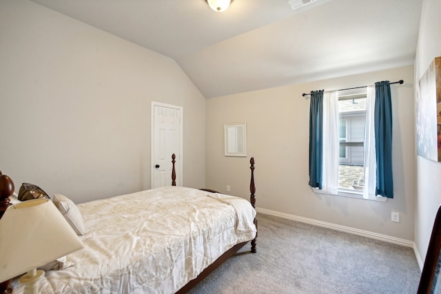 bedroom featuring lofted ceiling and carpet