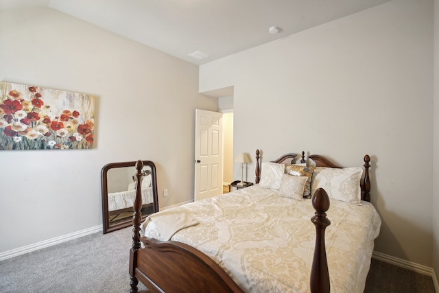 bedroom with vaulted ceiling and carpet floors