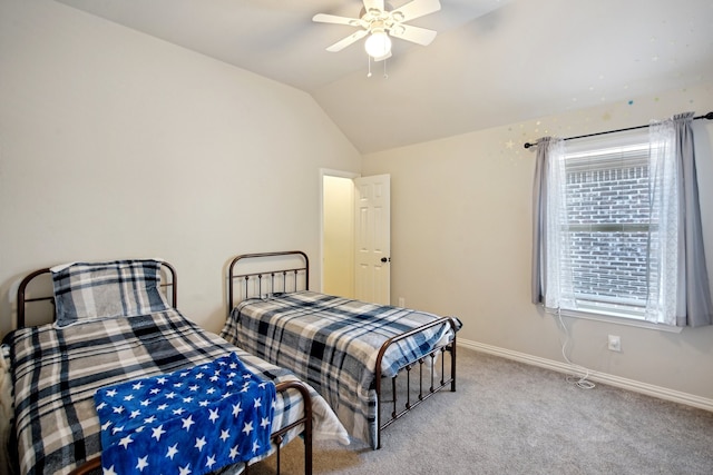 carpeted bedroom with ceiling fan and vaulted ceiling