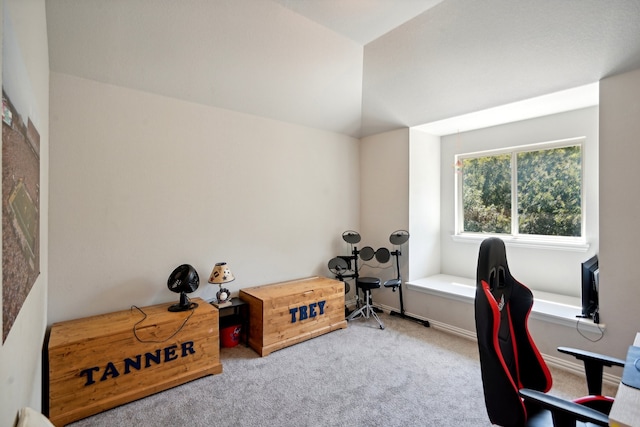 carpeted home office with lofted ceiling