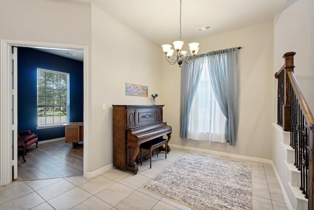 foyer with light hardwood / wood-style flooring and a chandelier