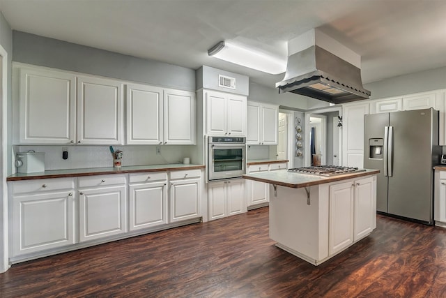 kitchen with dark wood-type flooring, white cabinets, a kitchen island, island exhaust hood, and stainless steel appliances