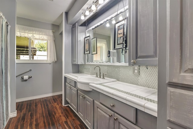 bathroom featuring decorative backsplash, hardwood / wood-style floors, and vanity