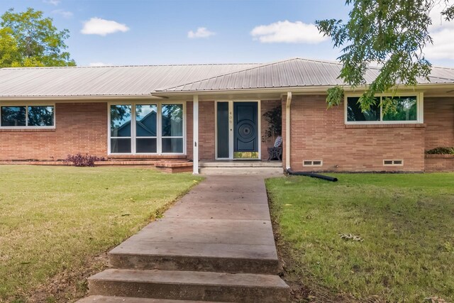 ranch-style home with a front lawn