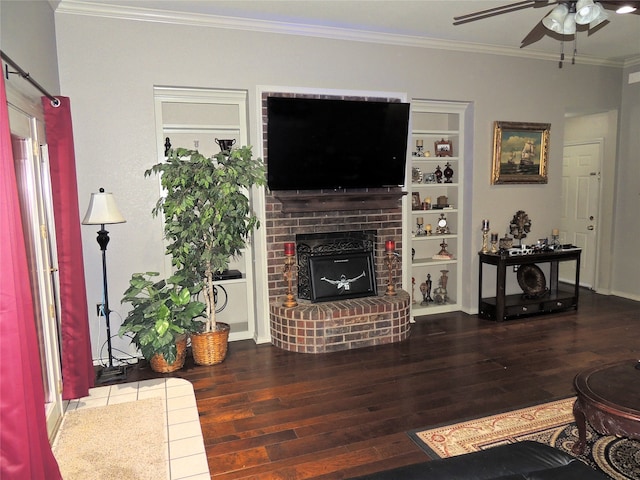 living room featuring ceiling fan, a fireplace, hardwood / wood-style floors, and ornamental molding