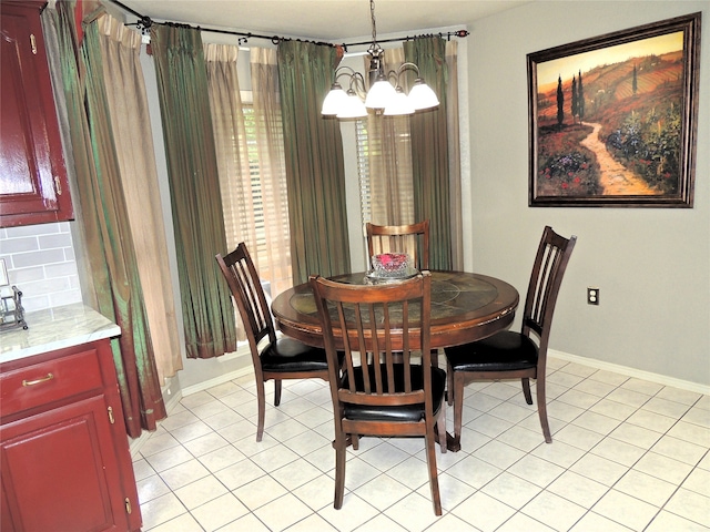 dining space featuring an inviting chandelier and light tile patterned flooring