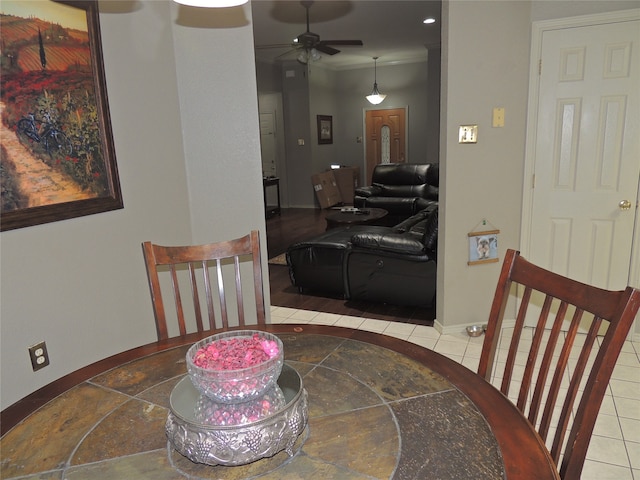 tiled dining area with ceiling fan