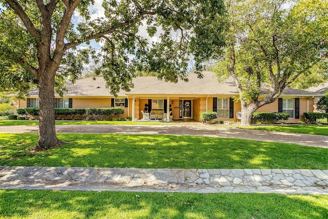 ranch-style home with a front yard and a porch