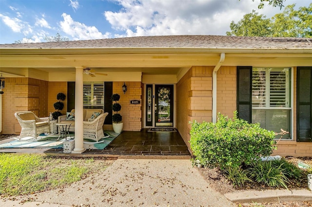 view of exterior entry featuring a patio area and ceiling fan