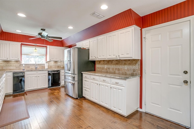 kitchen with stainless steel fridge, white cabinets, black dishwasher, ceiling fan, and light hardwood / wood-style flooring