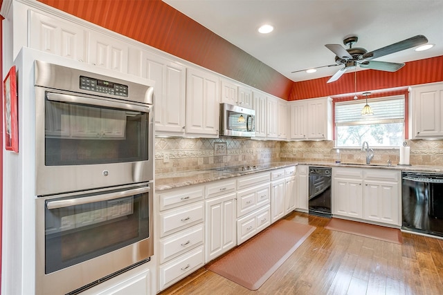 kitchen featuring white cabinetry, light wood-type flooring, black appliances, ceiling fan, and sink