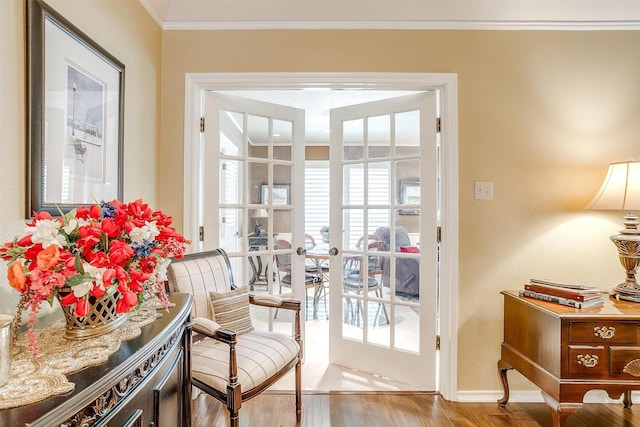 entryway with wood-type flooring and crown molding