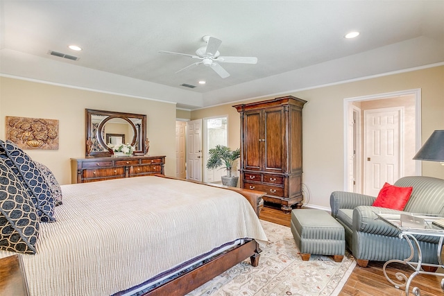 bedroom with light hardwood / wood-style flooring and ceiling fan