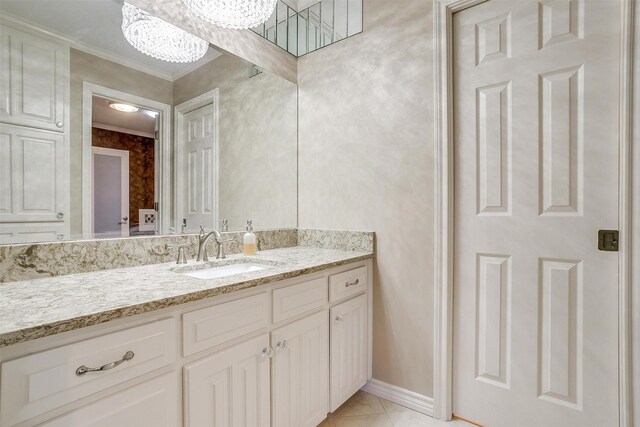 bathroom with vanity, crown molding, and tile patterned flooring