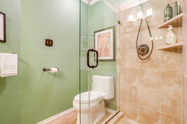 bathroom with walk in shower, crown molding, tile patterned flooring, and toilet