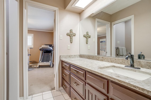 bathroom featuring ornamental molding, tile patterned flooring, and vanity