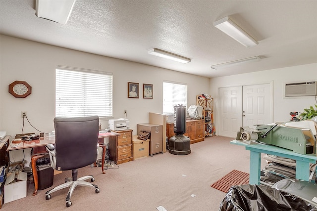 office space with a textured ceiling, carpet, and a wall unit AC