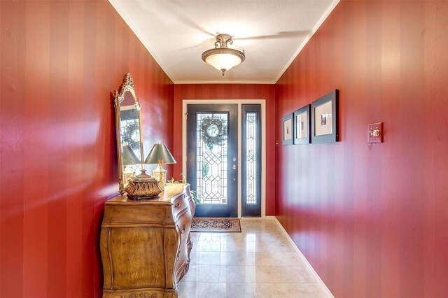 tiled foyer featuring ornamental molding