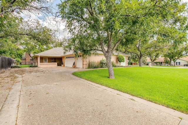 view of front of property featuring a garage and a front lawn