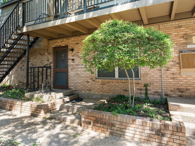 7931 Royal Ln Unit 115, Dallas, TX 75230 - property entrance featuring brick siding and a balcony