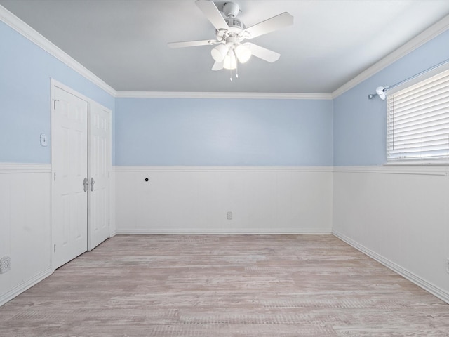 7931 Royal Ln Unit 115, Dallas, TX 75230 - empty room with crown molding, a ceiling fan, wood finished floors, and a wainscoted wall