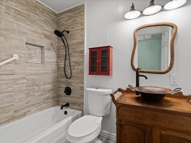 full bathroom with vanity, tiled shower / bath combo, and toilet