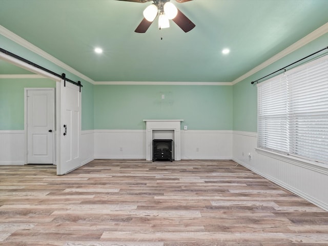 7931 Royal Ln Unit 115, Dallas, TX 75230 - unfurnished living room with ceiling fan, wainscoting, and wood finished floors