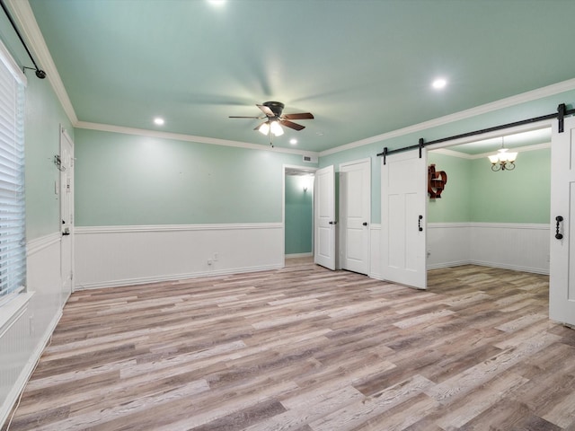 7931 Royal Ln Unit 115, Dallas, TX 75230 - unfurnished bedroom featuring light wood-style floors, a barn door, wainscoting, and recessed lighting