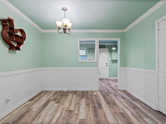 7931 Royal Ln Unit 115, Dallas, TX 75230 - spare room with an inviting chandelier, wainscoting, and wood finished floors