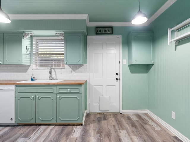 kitchen featuring white dishwasher, decorative light fixtures, light wood-type flooring, and wooden counters