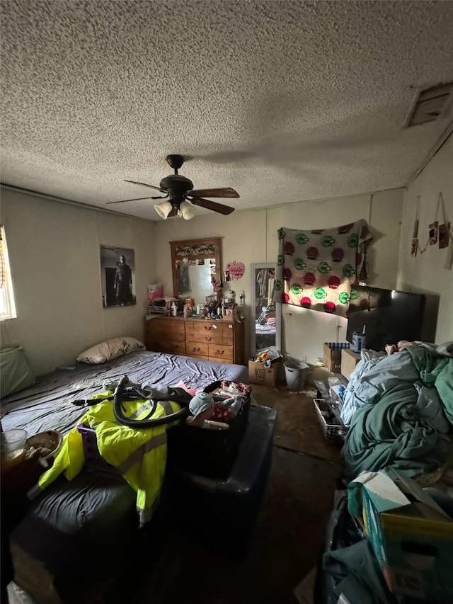 bedroom featuring a textured ceiling and ceiling fan